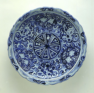 Foliated Platter (Pan) with the Eight Buddhist Symbols (Bajixiang), Flowers, and Waves, China, Jiangxi Province, Jingdezhen, late Yuan dynasty, circa 1340-1368, ceramic, porcelain, molded porcelain with blue painted decoration under clear glaze, gift of the Francis E. Fowler, Jr., Foundation and the Los Angeles County Fund, photo © 2012 Museum Associates/LACMA 