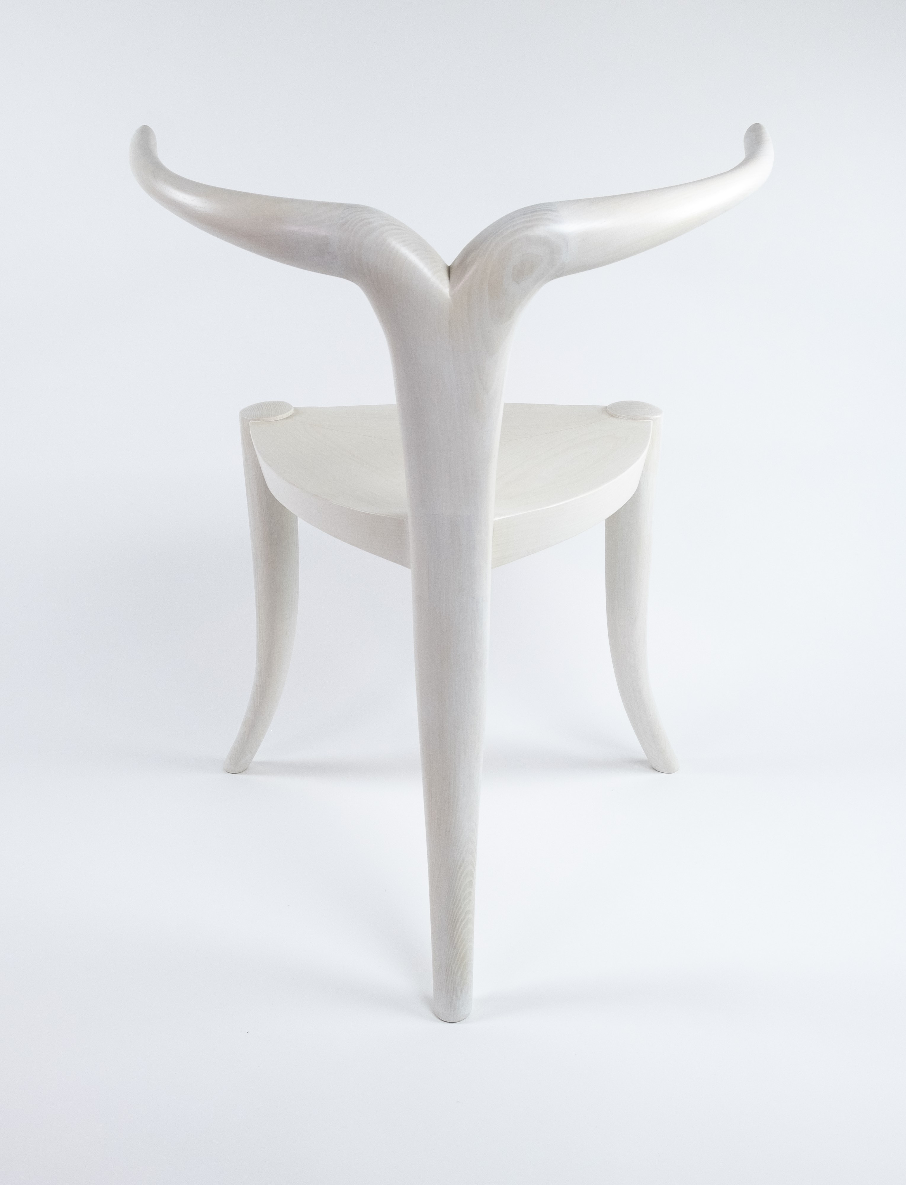 White chair with curved legs and back