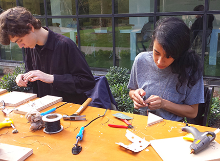 Derelict Electronics participants at work on amplifiers and solar cells. 