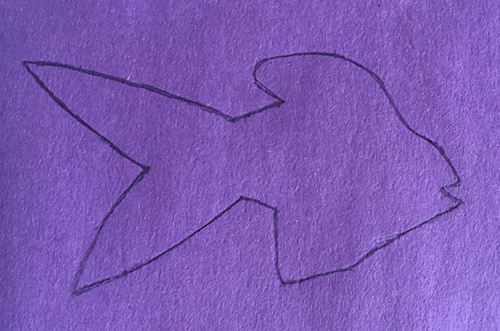 Outline of a fish drawn on purple paper