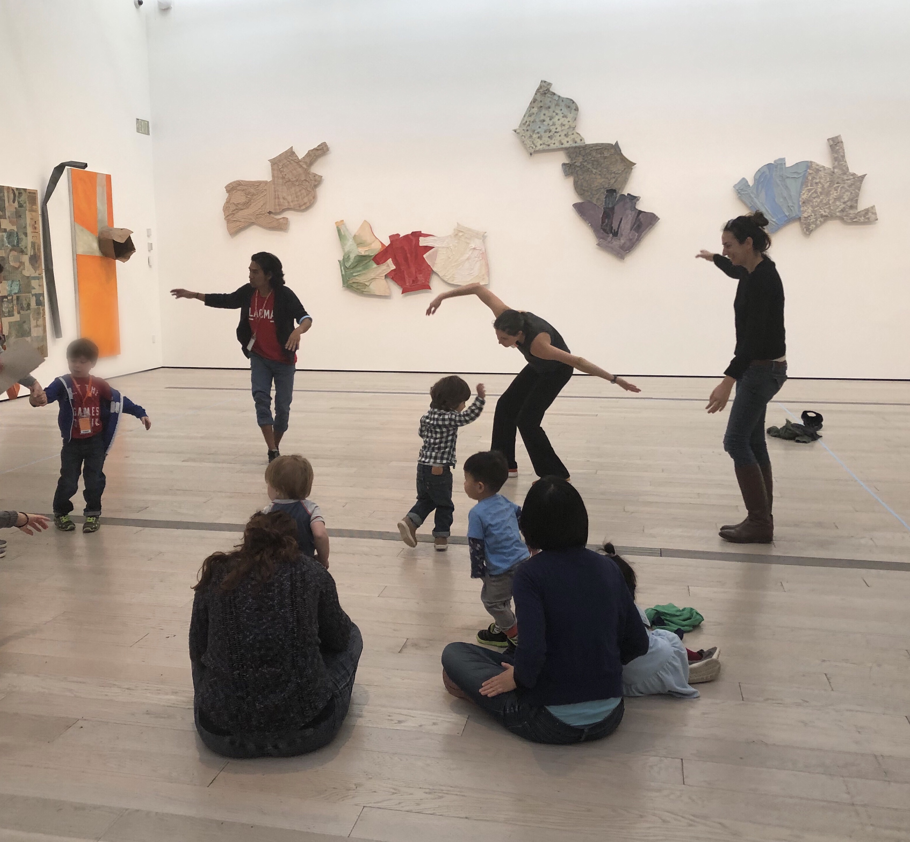 Andell Family Sundays participants dancing in front of Robert Rauschenberg's The 1/4 Mile or 2 Furlong Piece.