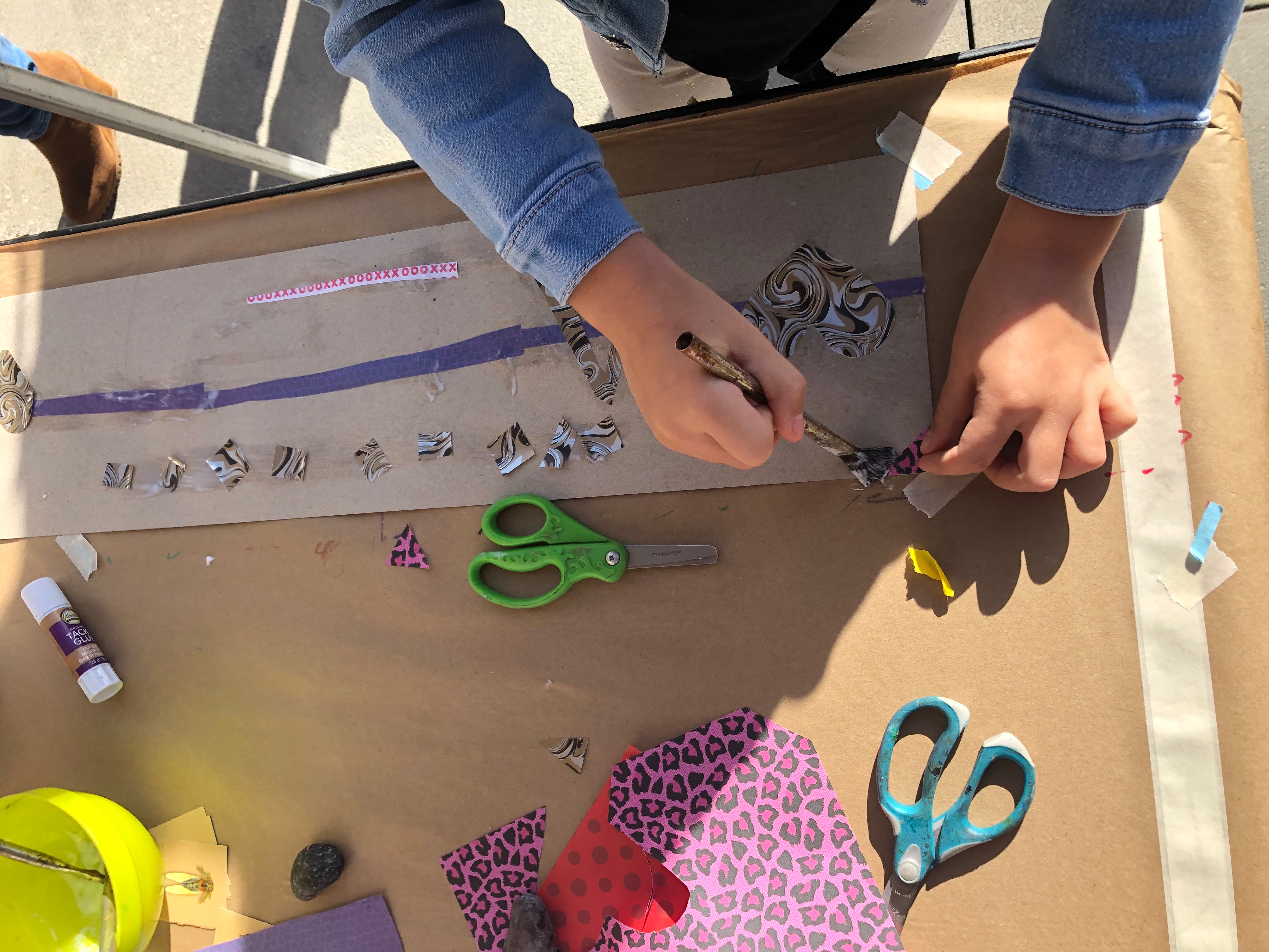 Child working on a collage.