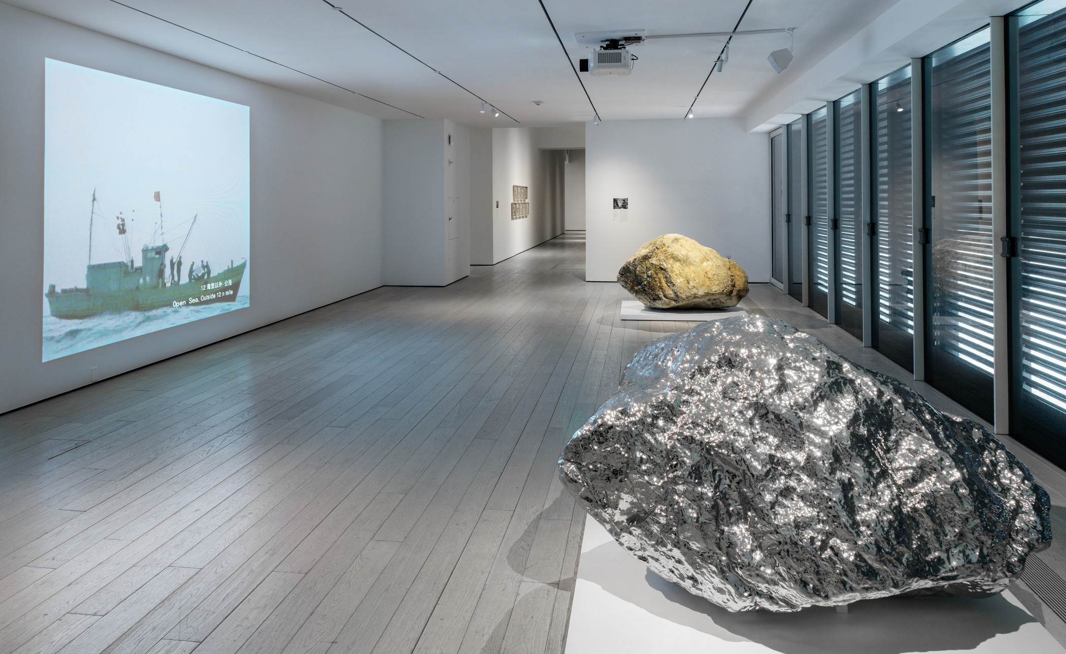 Installation photograph, featuring Zhan Wang's Beyond 12 Nautical Miles Floating Rock Drifts on the Open Sea (2000) and Gold Mountain (2007), in the exhibition The Allure of Matter: Material Art from China, at the Los Angeles County Museum of Art, June 2, 2019–January 5, 2020, © Zhan Wang, photo © Museum Associates/LACMA