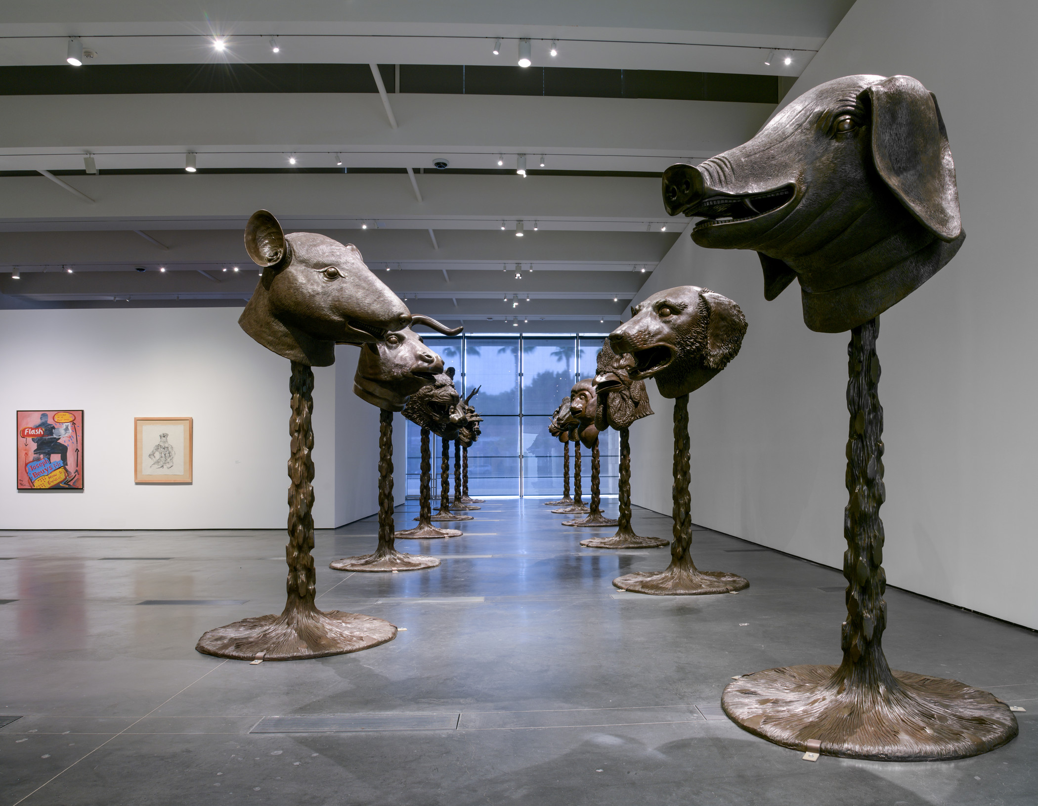 Gallery view of a row of animal head sculptures