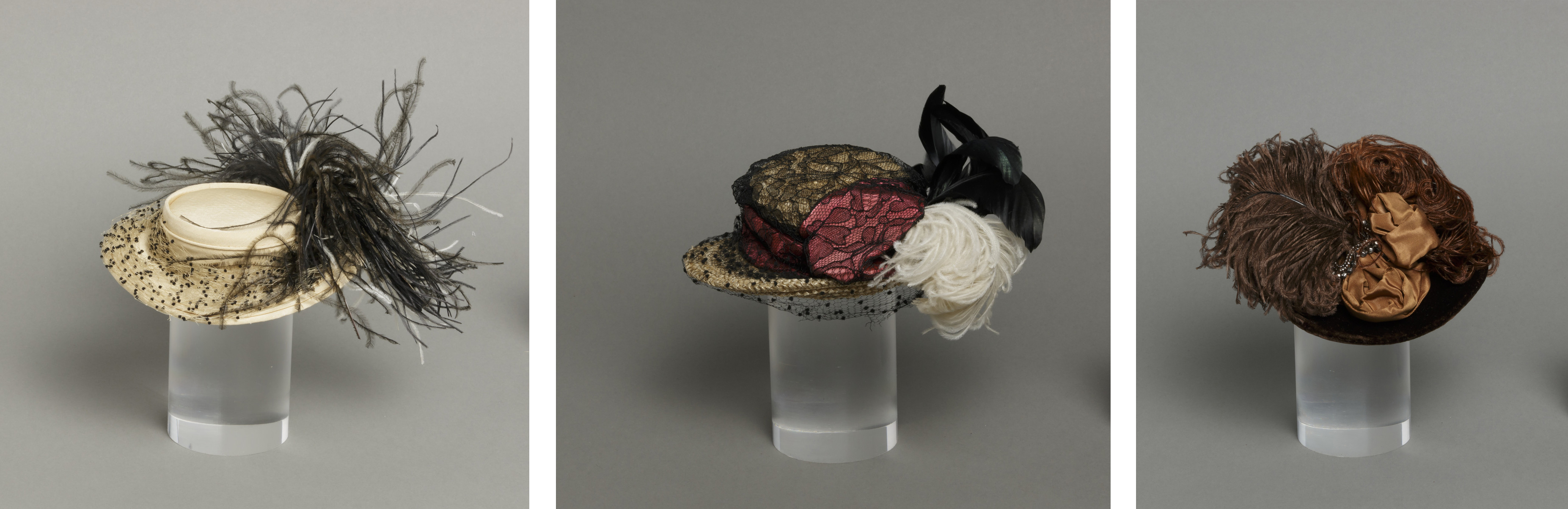 Three miniature hats decorated with feathers, lace, and flowers