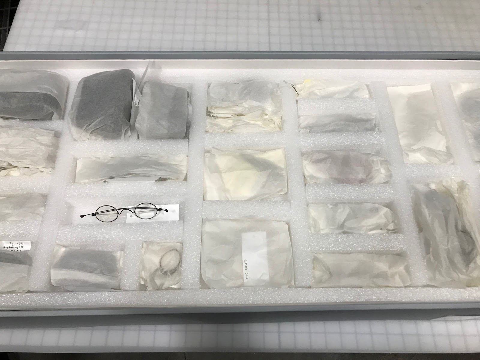 Cavity tray containing glass eyewear with metal frames.