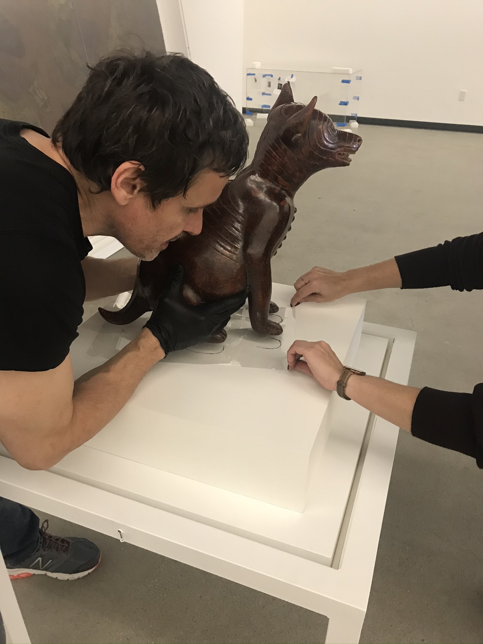 Dog, Mexico, Colima, 200 BCE–500 CE, Los Angeles County Museum of Art, The Proctor Stafford Collection, purchased with funds provided by Mr. and Mrs. Allan C. Balch. Giorgio Carlevaro, senior art preparator, installing the sculpture, photo courtesy of Dawn Turner