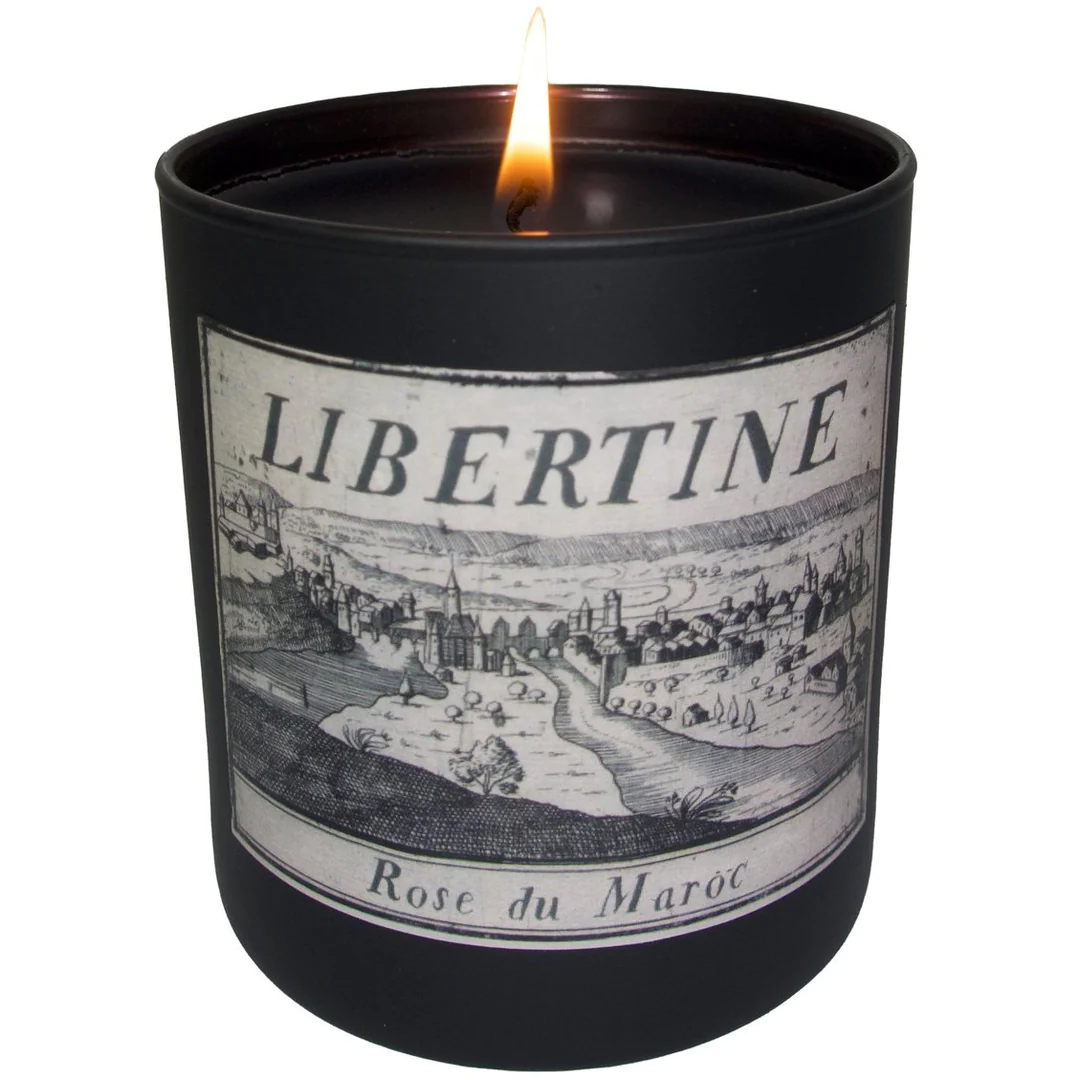 Black cylinder with candle wick visible, with a label that says Libertine Rose due Maroc on it