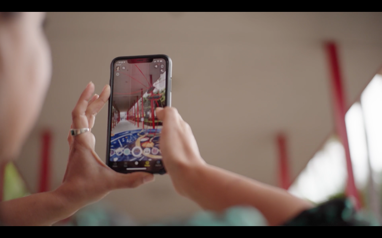 Hands holding smartphone to view AR artwork