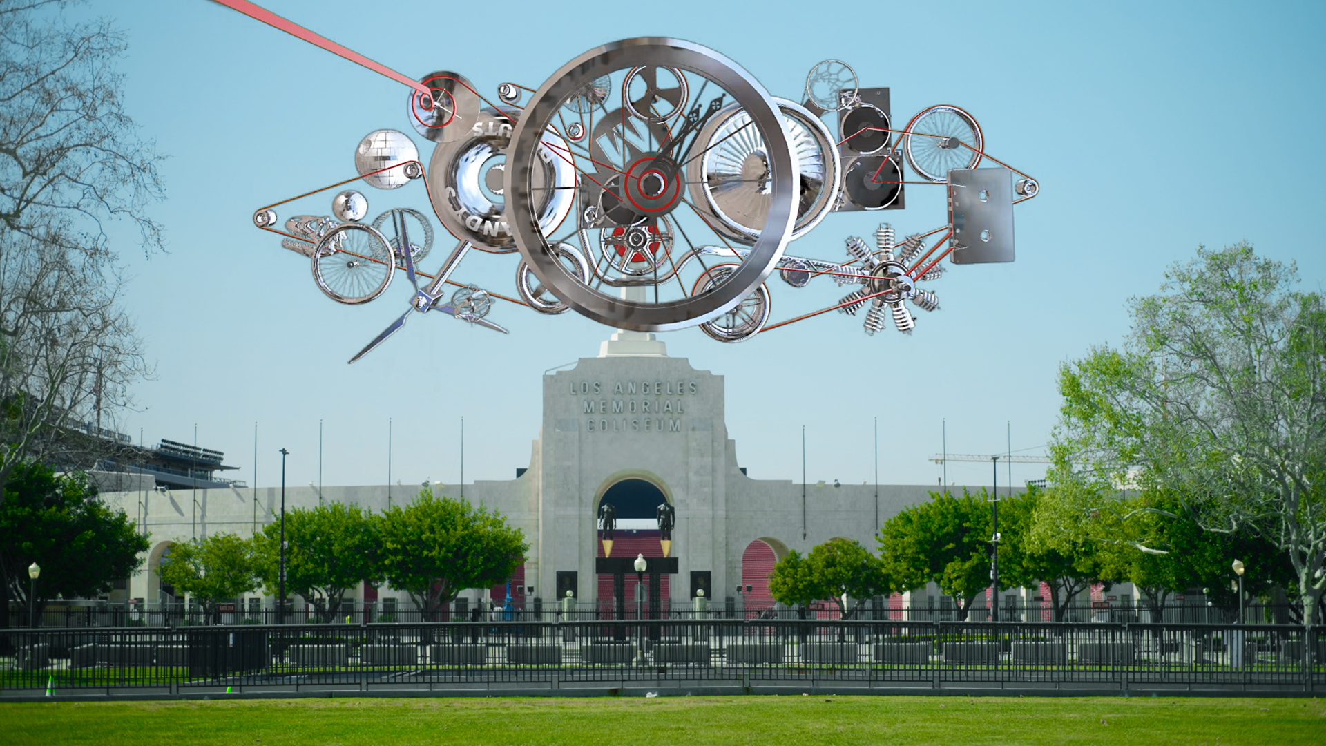 Metallic wheels and gears float above a photo of the L.A. Memorial Coliseum