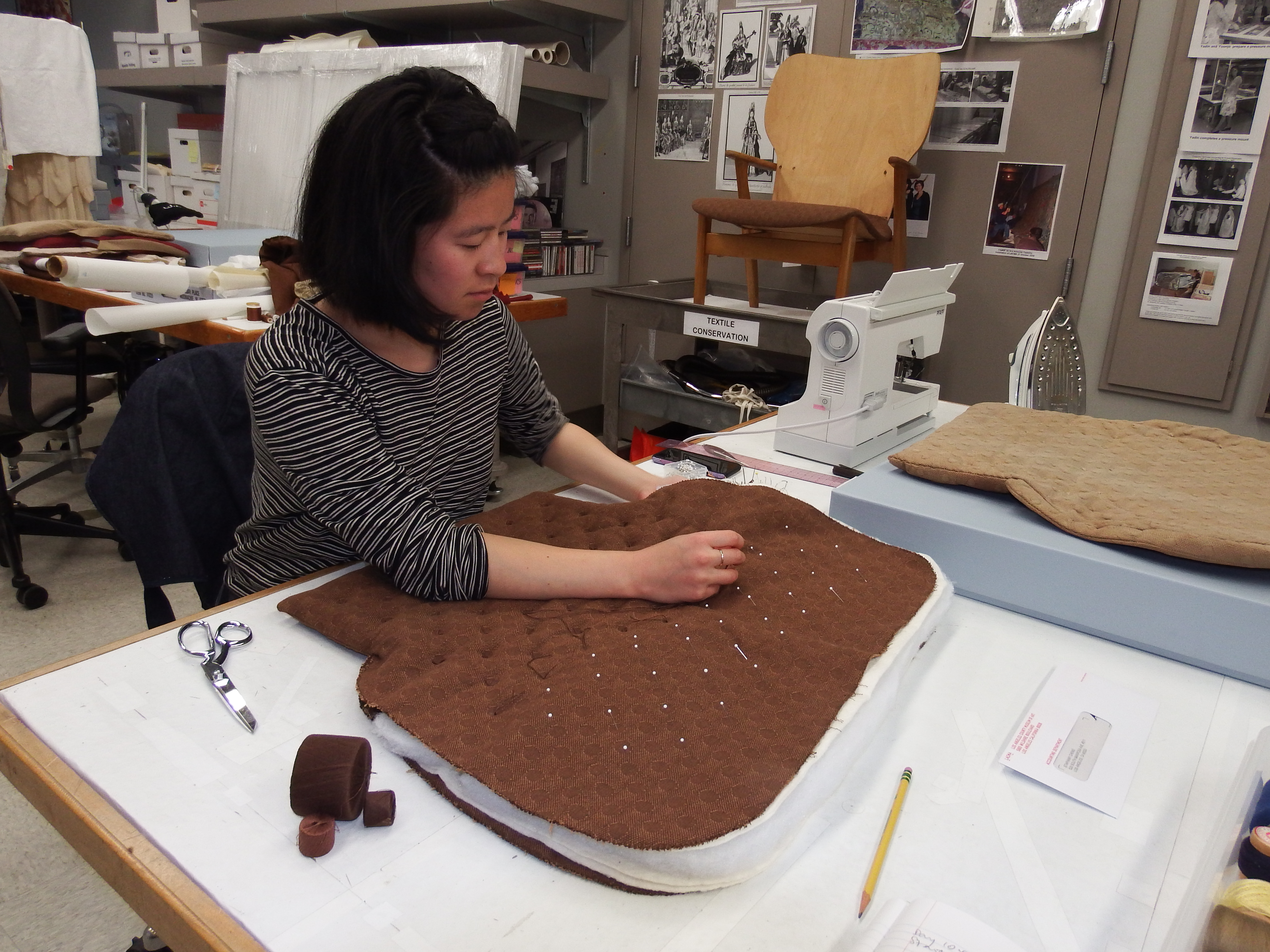 Staphany Cheng, textile conservation Andrew W. Mellon Fellow, tufting the reproduced cushion, photo © Museum Associates/LACMA Conservation, by Catherine McLean