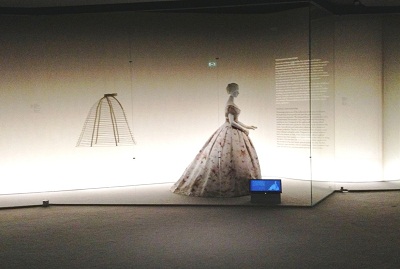 View of a mid-19th century crinoline and dress on the second floor of Fashioning Fashion