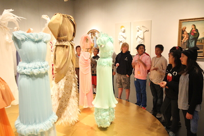 Students discuss the Rodarte gowns, making connections to the adjacent Italian Renaissance paintings.