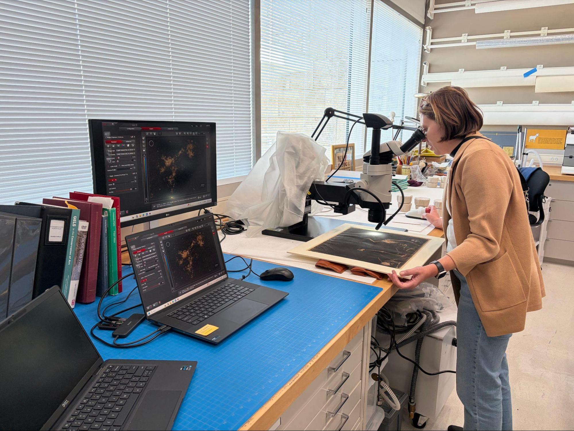 Michelle Sullivan, conservator of drawings at the Getty Museum, examines Redon’s Battle of the Bone. Image: Getty Museum. © J. Paul Getty Trust
