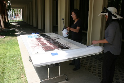 Associate Conservator, Soko Furuhata, humidifying the print with a Dahlia sprayer.