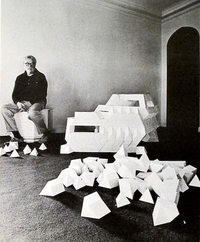 Tony Smith next to a model composed of tetrahedrons and octahedrons (with additional maquette modules in the foreground) [Photographer: Malcolm Lubliner]