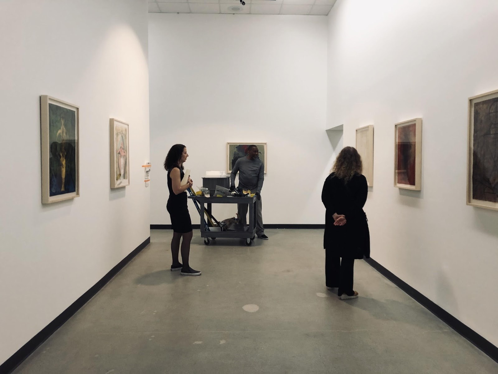 Installation photograph of Rufino Tamayo: Innovation and Experimentation, Los Angeles County Museum of Art at Charles White Elementary School Gallery, December 21, 2019–July 11, 2020, art © 2020 Tamayo Heirs/Mexico/Artists Rights Society (ARS), New York. From left to right: Rachel Kaplan, assistant curator of Latin American Art; Cedric Adams, senior art preparator; Ilona Katzew, curator and department head of Latin American Art, photo: Deliasofia Zacarias Installation photograph of Rufino Tamayo: Innovation and Experimentation, Los Angeles County Museum of Art at Charles White Elementary School Gallery, December 21, 2019–July 11, 2020, art © 2020 Tamayo Heirs/Mexico/Artists Rights Society (ARS), New York. From left to right: Rachel Kaplan, assistant curator of Latin American Art; Cedric Adams, senior art preparator; Ilona Katzew, curator and department head of Latin American Art, photo: Deliasofia Zacarias
