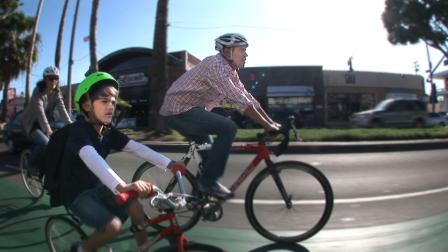 A family rides on the Sharrows in Long Beach