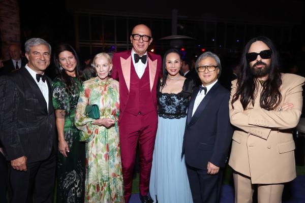 Photo of seven people in suits and gowns