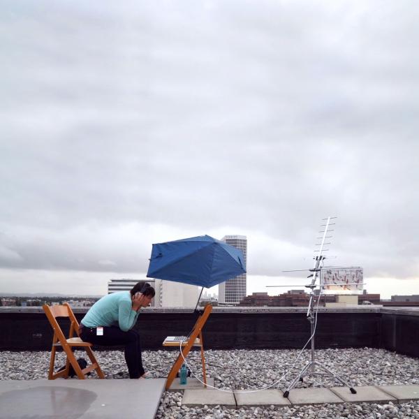 Kata Kovács tracking satellite signals on the roof at LACMA, August 2017, © Kovács/O’Doherty
