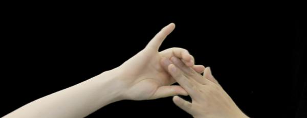 image of hands against a black background