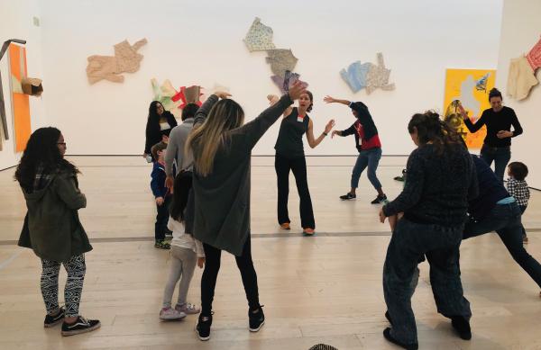 People dancing in front of Robert Rauschenberg's The 1/4 Mile or 2 Furlong Piece