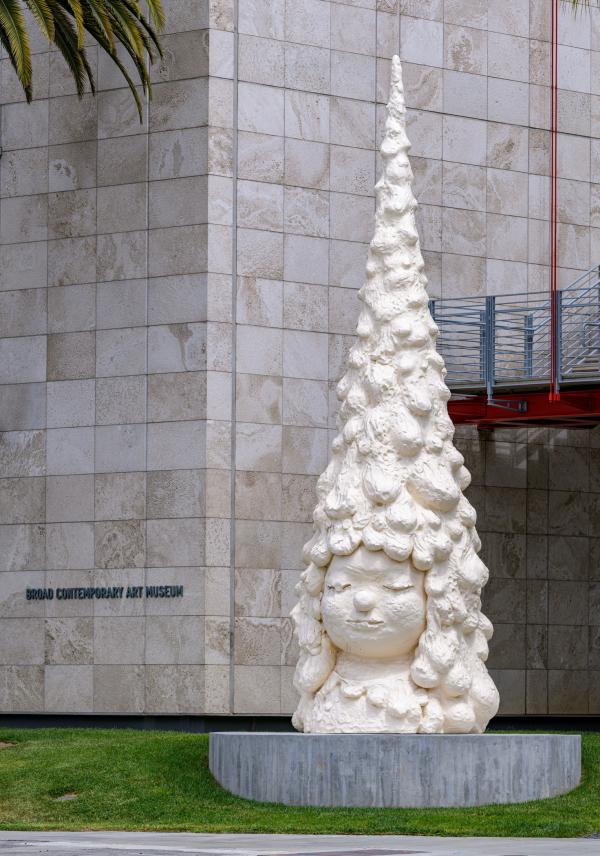 image of Yositomo Nara's outdoor sculpture Miss Forest—sculpture of a girls head, her hair shaped like a tannenbaum