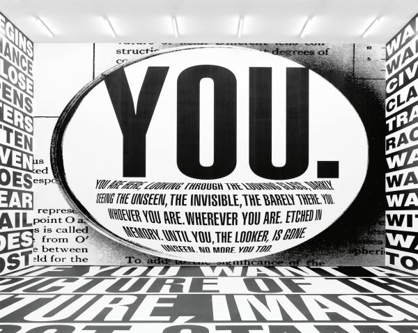 Room-size installation with black and white text on walls and floor, including the word "You"