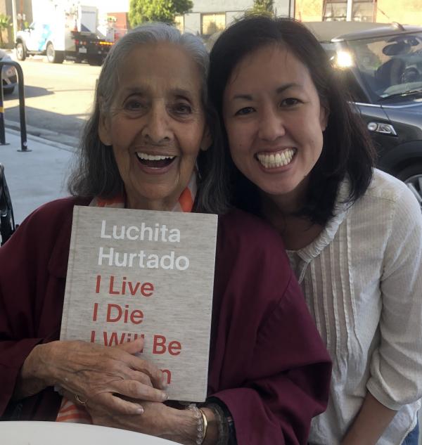 Luchita Hurtado and curator Jennifer King with the catalogue for I Live I Die I Will Be Reborn