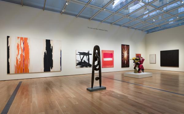 Gallery view with sculptures and paintings