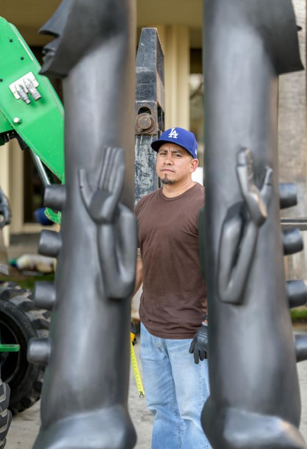 Gerardo “Shorty” Arcienaga pictured at the deinstall of Zak Ové’s 2019 installation, The Invisible Man and the Masque of Blackness, art © Zak Ové, photo by Senior Art Preparator Giorgio Carvelaro