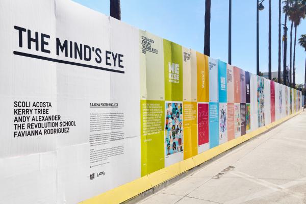 Colorful posters line a construction wall