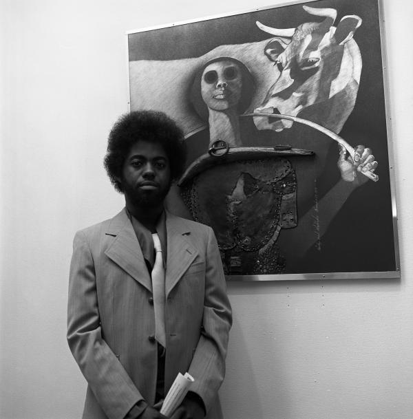 Black and white photo of Timothy Washington in front of painting