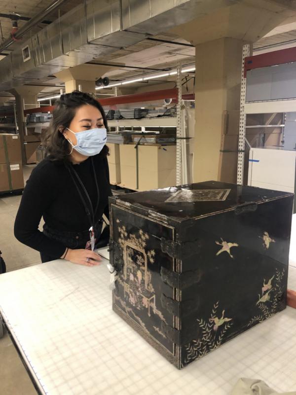 Young woman in front of Japanese lacquer chest