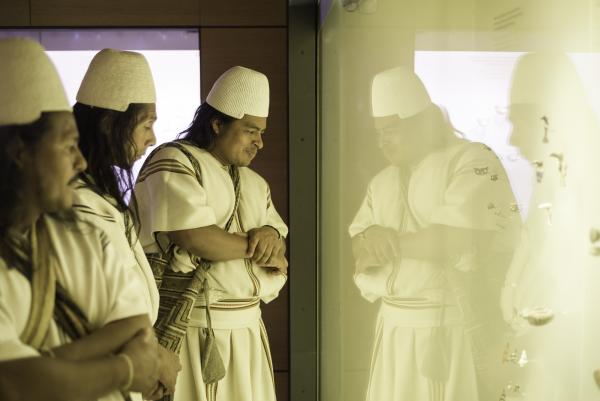 Members of the Arhuaco community looking at Tairona objects in the Museo del Oro Santa Marta