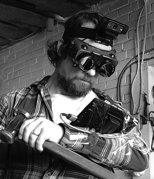 Black and white photo of man wearing hi-tech goggles