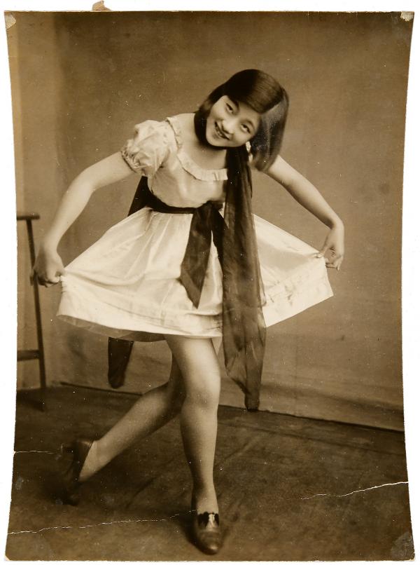 Vintage photo of young woman curtsying 