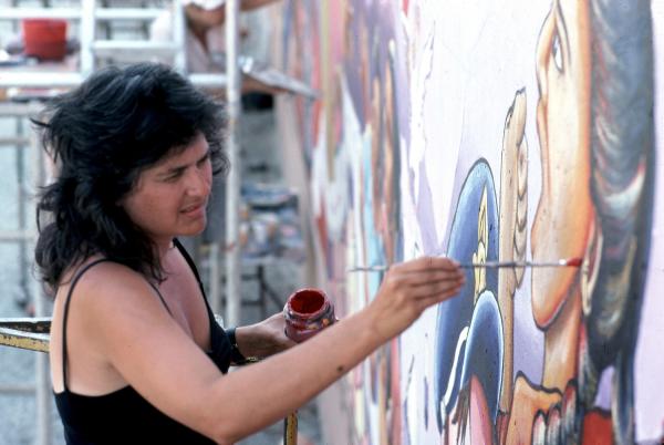 Photo of woman painting wall mural