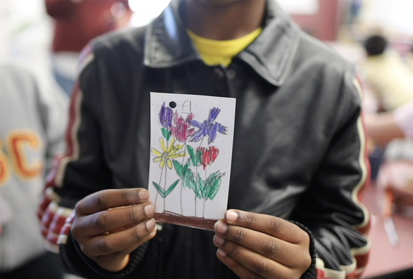 Close up photo of a drawing held up by a child