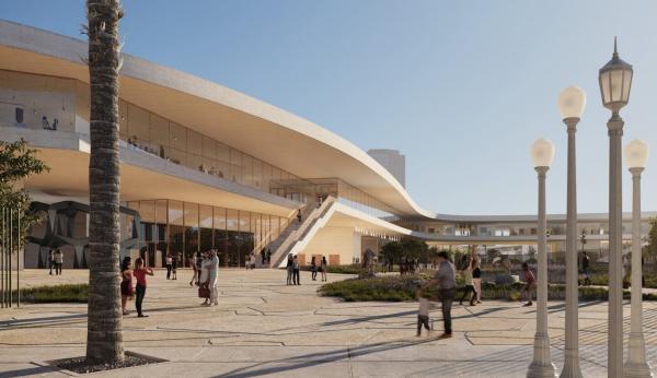 Exterior view of museum building with people and sculptures on plaza