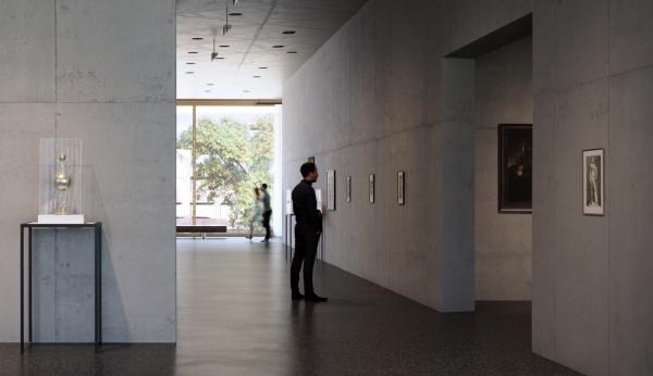 A person views art on the walls in a gallery with the outdoors visible in the background