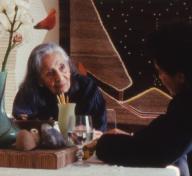Film still of two women sitting down and talking