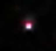 black image with square-shaped pink light in the center