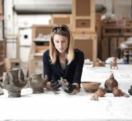 Julia Burtenshaw, LACMA's assistant curator for the Art of the Ancient Americas department studying Colombian artifacts from LACMA's collection. 