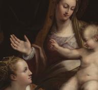 A woman and two children, and a man standing behind them