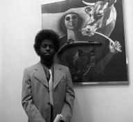 Black and white photo of Timothy Washington in front of painting