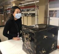 Young woman in front of Japanese lacquer chest