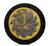 Circular black and yellow object with feather design
