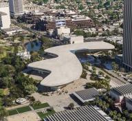 Aerial view of pale, organically shaped building crossing Wilshire Boulevard