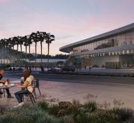 Rendering of museum building at dusk with visitors at cafe tables in the foreground